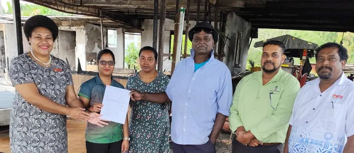 Venesh Kumar (fourth from left) receiving his document.