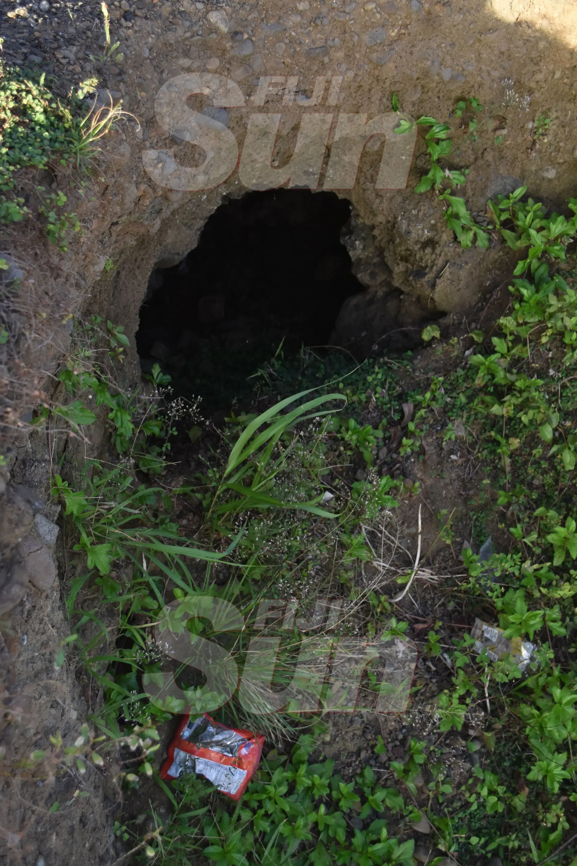 Coastal waters created this hole on the side of the road. Photo: Selita Bolanavanua.