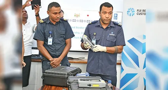 Fiji Revenue and Customs Service officer Meli Serunituacoko, {left), shows the new drug testing machine. PHOTO: Ronald Kumar
