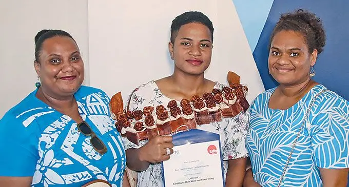 Australia Pacific Training Coalition graduate Ruci Vuakilau, (middle), is flanked by Makereta Voi, (left), and Grace Voliti. during the graduation in Suva on October 9, 2024. Photo: Sosiveta Korobiau