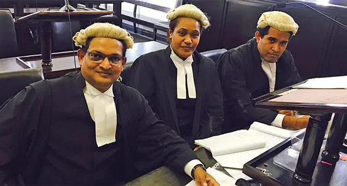 Susan Serukai (middle) with colleagues at the Suva Court.