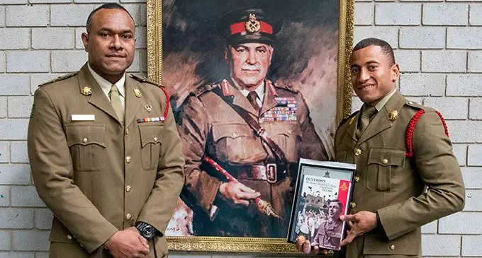 Republic of Fiji Military Forces Major Pio Varawa (left) with Staff Cadet Viliame Matai, awarded the Stuckey Mitchell prize and  outstanding international cadet award last week in front of the Field Marshall Blamey photo at the Royal Military  College – Duntroon. Photo: Australian High Commission