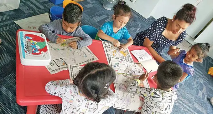 Children of Priti’s Preschool and Daycare Center in Nakasi learning and drawing.  Photo: Priti Lata