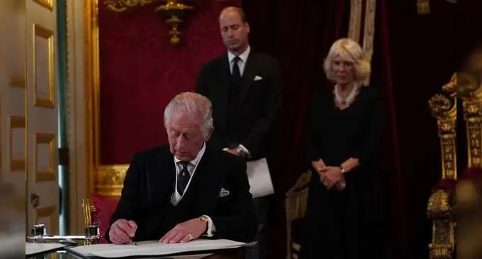 King Charles III signs an oath to uphold the security of the Church in Scotland during the Accession Council at St James’s Palace, London.. Photo: Al Jazeera