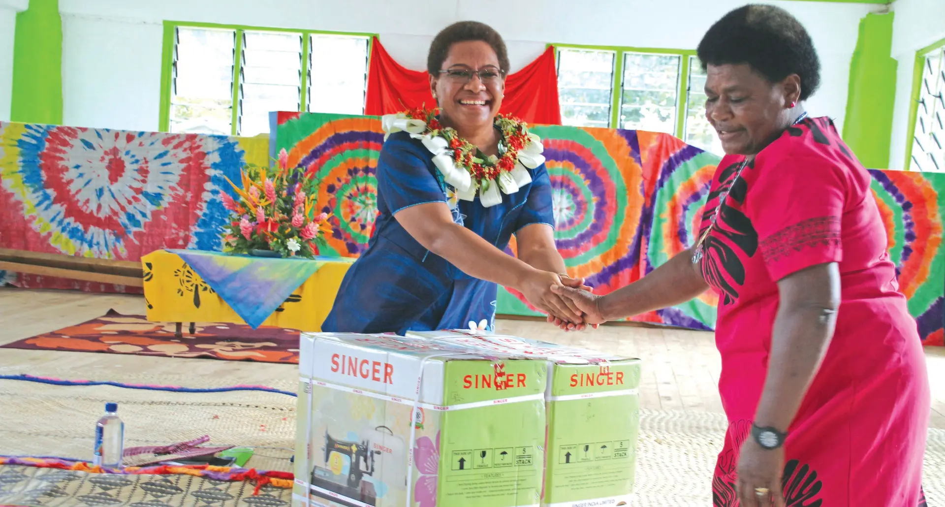 Minister for Women, Children and Poverty Alleviation Mereseini Vuniwaqa handing over sewing machines. Photo: Ministry of Women, Children and Poverty Alleviation