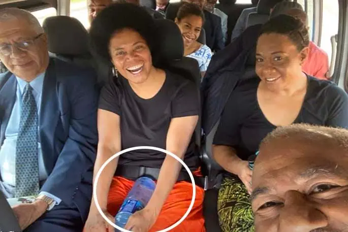 Lenora Qereqeretabua holding a plastic water bottle on her way to Sigatoka
