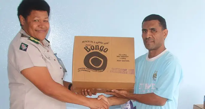 Fiji Corrections Service director Rehabilitation Senior Superintendent Salote Panapasa handing assistance items to Mausio Susau under the Poverty Alleviation Allocation. Photo: Maika Bolatiki