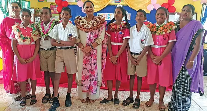 Kulukulu Public School head teacher, Sharina Riaz (left), the Minister for Industry, Trade, Tourism, Local Government, Housing and Development, Premila Kumar (fifth from left), Year 8 teacher, Sanjana Singh (far right) with the school prefects deputies, assistants and heads after the Prefect Badge Induction Ceremony on March 1, 2019. Photo: Nicolette Chambers