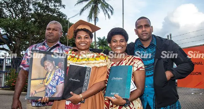From left: Father Etuate Bose, Josivini Waiwalu (holding a photoframe of their mother Jowana Nasakure) sister Jokaveti Waiwalu and brother Mosese Waiwalu after the University of the South Pacific graduation event at the FMF Gymnasium, Laucala Bay on May 12, 2022. Photo: Leon Lord