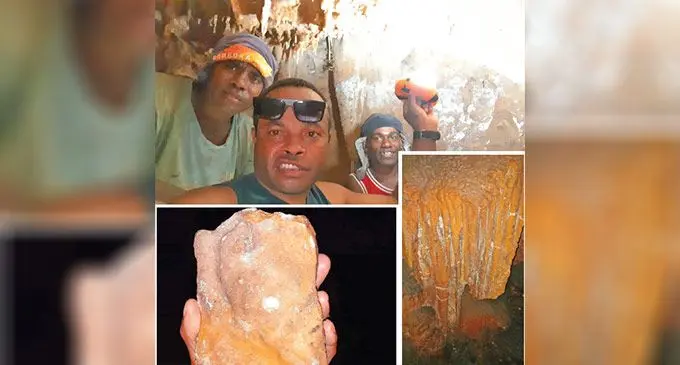 Inoke Turaga (front), with some villagers, showing images of rock formations found inside a cave in Nakorotubu, Ra.
