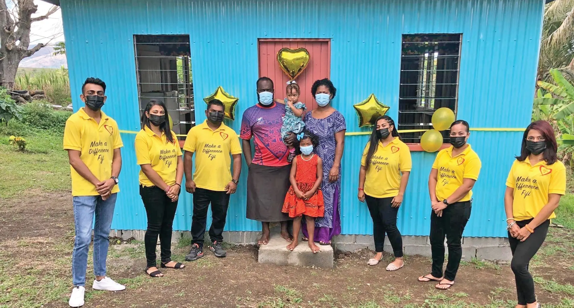 Mesulame Domonakibau, with wife Esita Lotu, daughters Mereoni and Lilieta surrounded by Make a Different (MAD) Fiji members in front of their new home in Navoli, Ba. Photo: Make a Difference Fiji