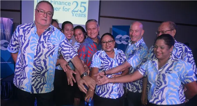 Credit Corporation Fiji managing director Peter Dixon (left) and former Reserve Bank Governor Berry Whiteside (fourth from left) with staff cut the cake to mark Credit Corporation’s 25 years in Fiji. Photo: RONALD KUMAR.