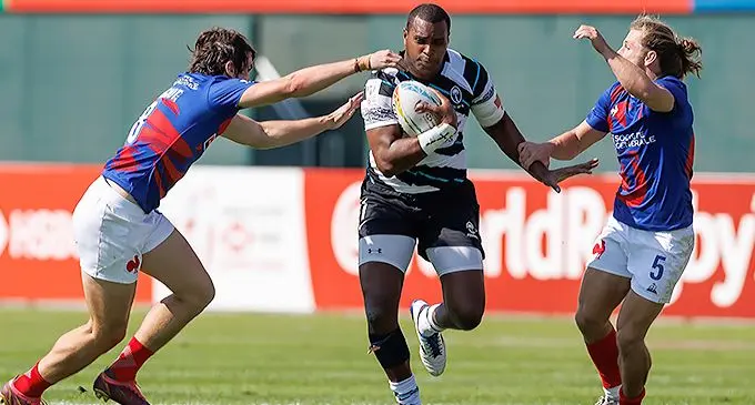 Fiji Airways Fijian 7s captain Josua Vakurinabili (with ball) bursts through two French players during the Dubai Sevens tournament on November 26, 2021.Photo: Emirates Dubai Sevens