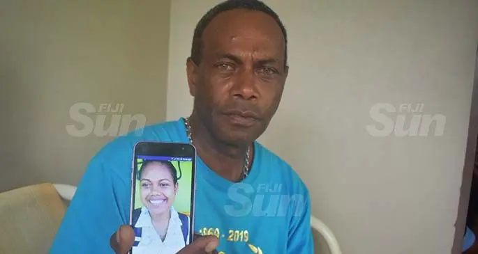 Vilimoni Roko with a photo of his late daughter Seruwaia Wairoaroa, at their home in Carreras Road, Votualevu in Nadi. Photo: Mereleki Nai