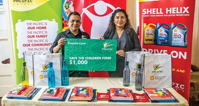 Pacific Energy (SWP) Limited chief marketing officer Rajesh Prasad presents the one hundred school packs and $1000 worth of pre-paid fuel cards to Save the Children Fiji chief executive officer, Shairana Ali at Save the Children Fiji headquarters in Suva on February 10, 2023. Photo: Pacific Energy (SWP) Limited