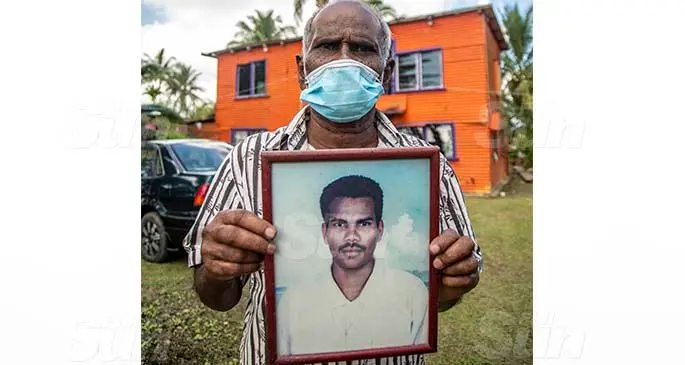 Ram Naresh holds a photgraph of his son Janesh Prasad. Photo: Leon Lord