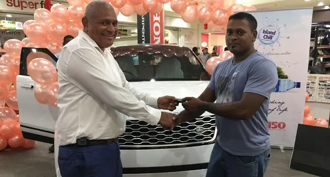 Carpenters Fiji Limited managing director, Daniel Whippy handing over the Range Rover Velar key to the winner Menal Nishal.Photo: Lusiana Tuimaisala
