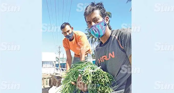 Sigatoka Valley Road farmers; Dinesh Varma, 46 and Ashneel Kumar, 36, hoping to make some sale on July 27, 2021. Photo: Ronald Kumar.