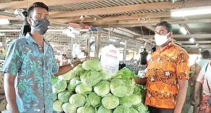 Tavua Market Vendors Association president,  Abdul Azim (right) with vendor, Anish Prasad inside the main market. 