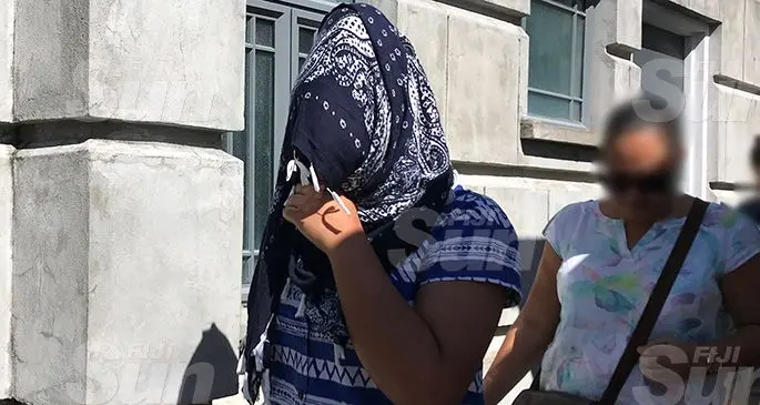 Mereseini Asinate Luisa Ledua (covering face), outside the Magistrates Court in Suva on December 9, 2019. Photo: Ashna Kumar
