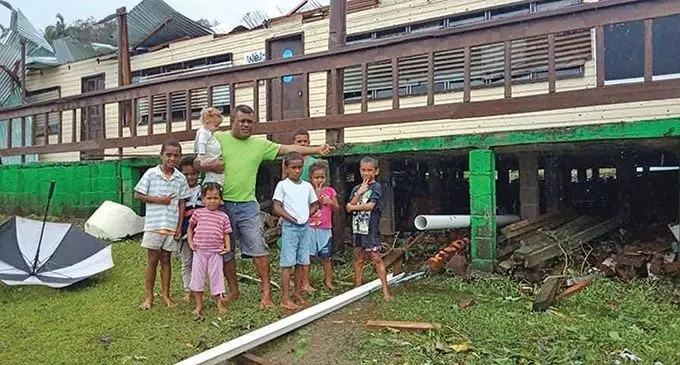 Leone Solovani with his children who took cover under a classroom floor in Togo, Qamea, on the night of December 17, 2020. Photo: Esiteri Adilailai 