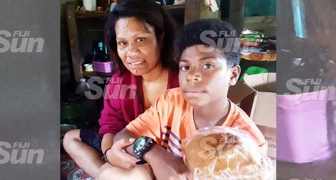 Raijeli Vasau, 41, bought a watch for her son, Iliasa Bola, from the little help she got from the public after she lost her job in a fire. Photo: Ronald Kumar