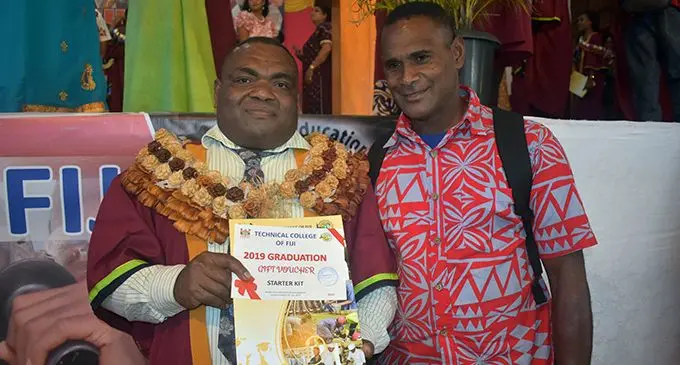 Sevuloni Rogo (left) with the Toge Village headman, Asesela Nalago (right) after the Technical College of Fiji graduation ceremony at the Xavier College auditorium in Ba on April 3.  Photo: Nicolette Chambers