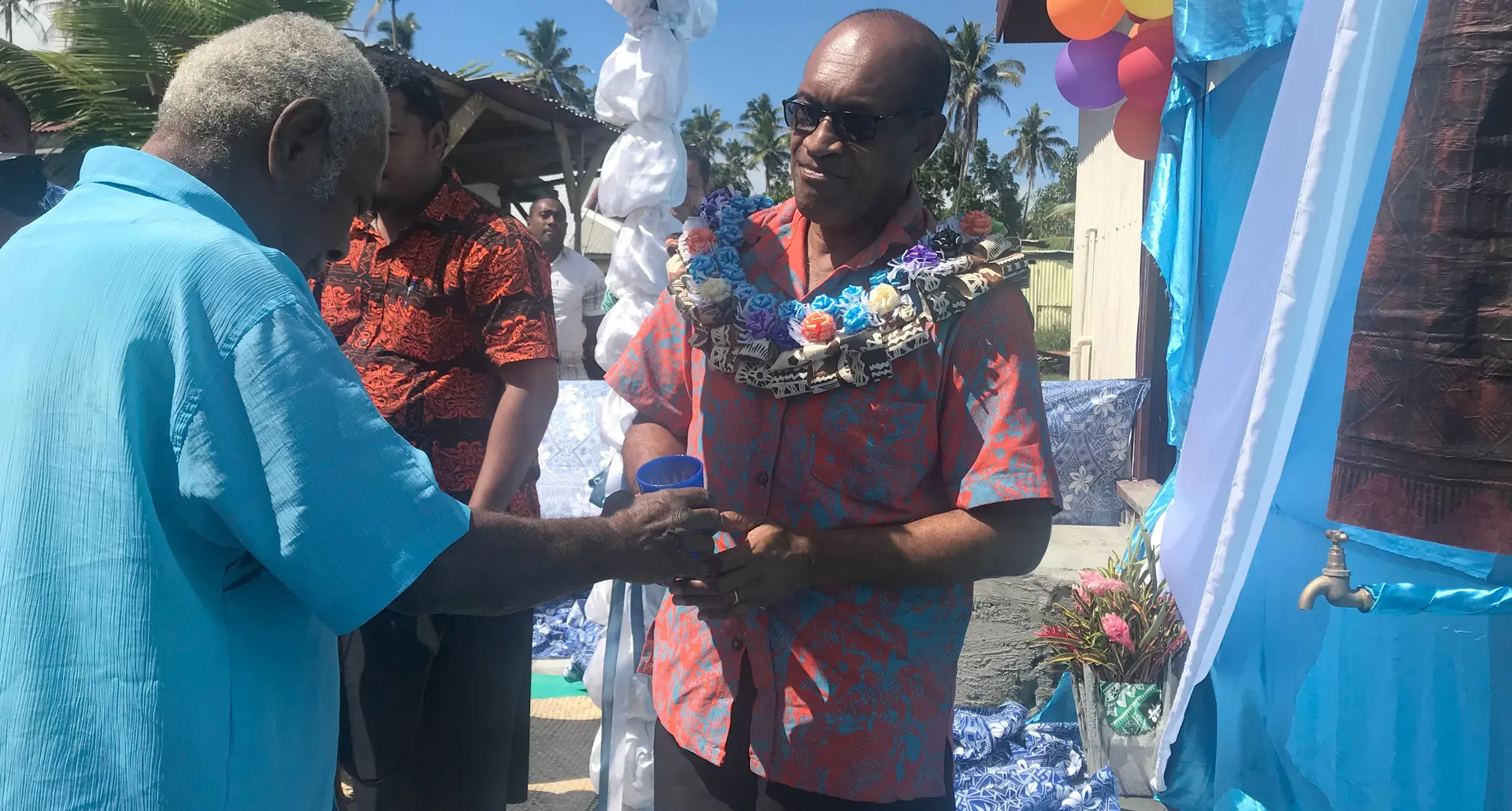 Minister for Infrastructure, Transport, Disaster Management and Meteorological Services Jone Usamate presenting a cup of water to Turaga na Ratu of Sawakasa Ratu Paula Namosimalua Loco on August 16, 2019. Photo: Selita Bolanavanua.