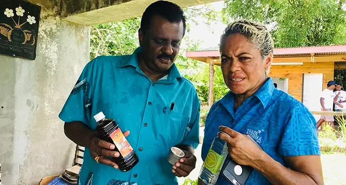 From left: Minister for Industrial Relations, Employment, Productivity, Youth and Sports, Parveen Bala and Vitilia Vuniwaqa having a look at some of her pure coconut oil and honey products.   Photo: Charles Chambers 