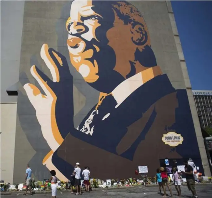 People mourn John Lewis, congressman representing the state of Georgia, near a mural of Lewis in Atlanta, Georgia, the United States, July 19, 2020. (Photo by Alan Chin/Xinhua)