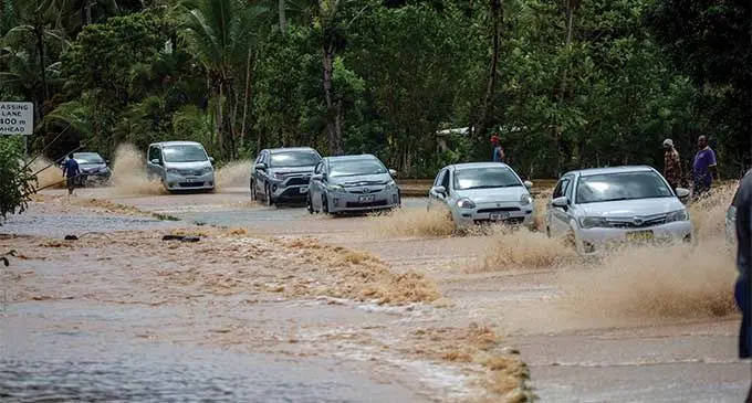 Drivers had to cross this flooded road on December 18, 2023, outside Galea Village with caution following 24 hours of heavy rain. Photo: Leon Lord