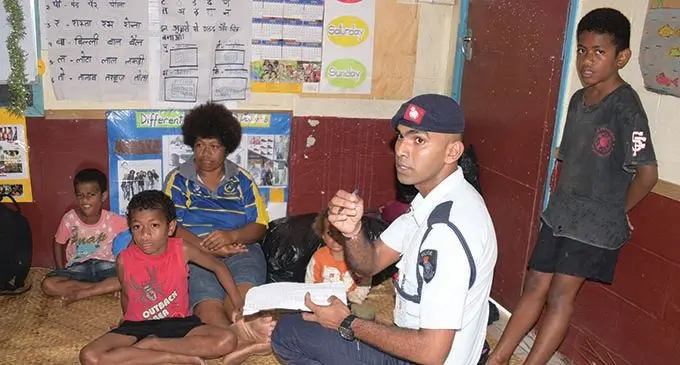 Police Constable Pranit Kumar takes details of evacuees at Nasinu Sangam Primary School on December 17, 2020 .  Photo: Ronald Kumar