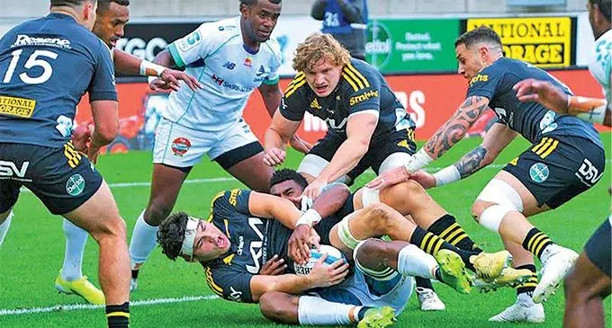 Hurricanes’ Tyler Laubscher, centre bottom, is tackled by Swire Shipping Fijian Drua flanker Kitione Salawa in their Super Rugby match in Wellington on May 8, 2022. Photo: AFP