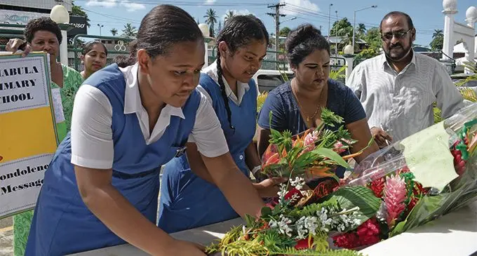 Samabula Primary School students, from left, Maria Tokalauvere, Varsha Ritika, teacher Kirti Kumar and head teacher Mohammed Firoz place flowers, wreaths and condolence messages from their fellow students yesterday at the Samabula Jame Masjid for the victims of terror attacks at two Christchurch mosques in New Zealand. 