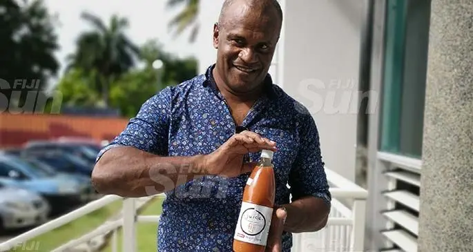 Juice Fiji operations manager Manasa Daunakamakama holding a Juice Fiji bottle.