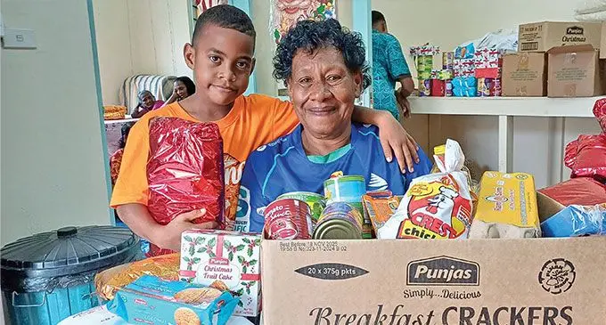 Litia Finau with her grandson, Elia Nainoka receiving their gift hamper at JP Bayly Trust in Labasa on December 24, 2024. Photo: Shratika Naidu