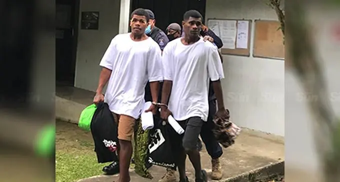  Raiwai incident accused persons,  Tomasi Qalibau (left), and Veleki Totogo,  escorted by the Police Special Response  Unit officers at the Magistrates Court in  Suva on August 16, 2022. Photo: Jone Salusalu