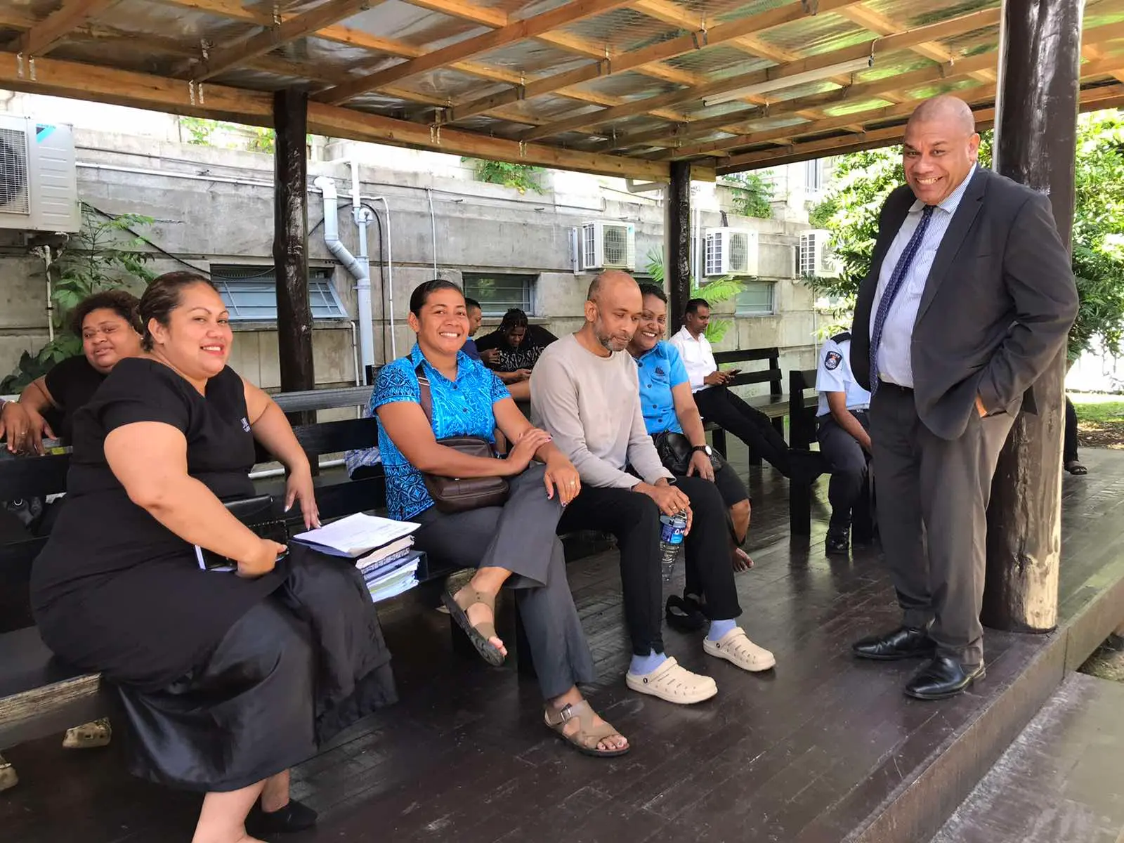 Accused person, Varinava Sabua (brown sweater) and his lawyer, Amani Bale (standing) outside the Suva Magistrates Court on December 23, 2025.