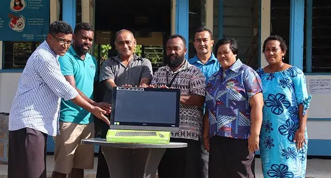 From left, Ministry of Education’s Paula Taufa, Fijian Competition & Consumer Commission’s Viliame Tabucala, Motusa District School head teacher, Marseu Mauveli, Fiji National Provident Fund’s Matai Daulako with school  staff, David Mamarasi, Linda Vunivai and Kasanita Liku upon receiving the brand new computer on September 6, 2022. Photo: Josefa Babitu