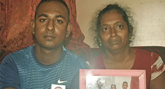Krishneel Kumar and his mother Sagita Devi Goundar on April 20, 2019, holding a family photo and a picture of the late Manoj Kumar. Photo: Mereleki Nai