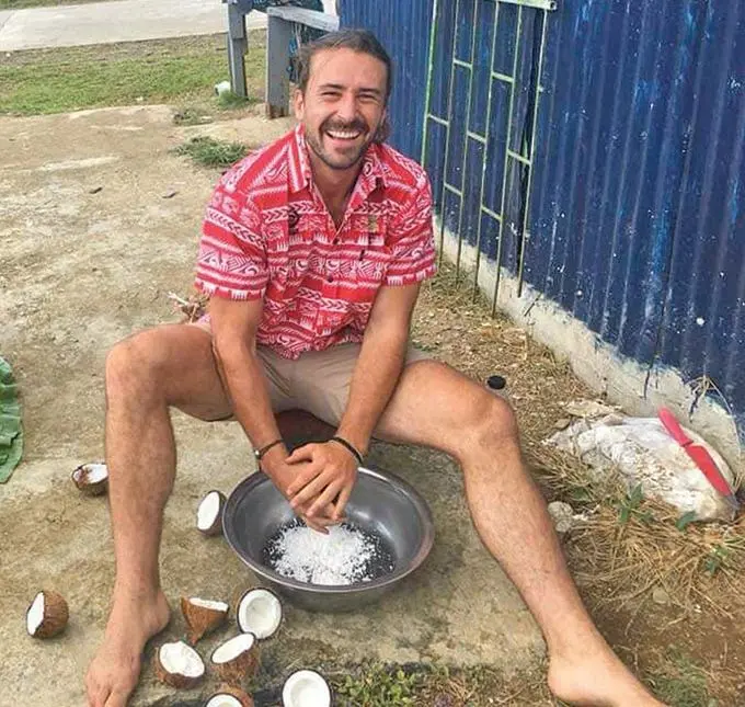 Harry McNulty scrapping coconut while in Fiji last year.