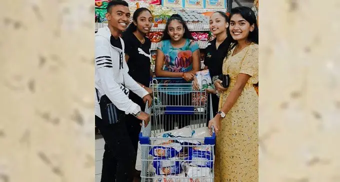 Malika Singh (left) with team members shopping for food drive.
