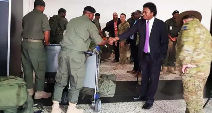 Fiji’s High Commissioner to Australia Luke Daunivalu greets the Fijian troops in Melbourne, Australia.