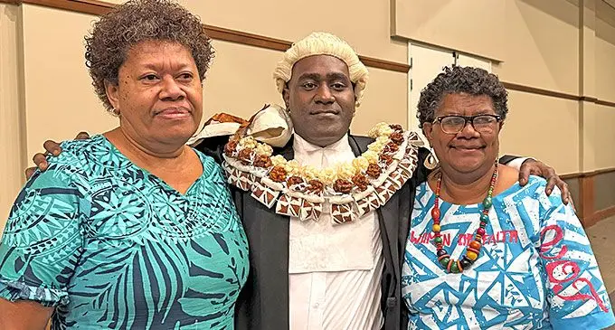 Newly-certified lawyer Pio Navara is surrounded by loved ones Akeneta Serelawa and Salaseini Turaga. Photo: Sosiveta Korobiau