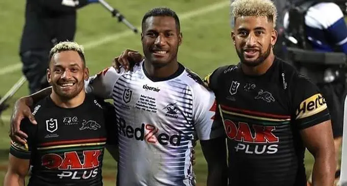Melbourne Storm winger, Suliasi Vunivalu (middle), is flanked by Penrith Panthers players, Api Koroisau (left)  and Viliame Kikau. 