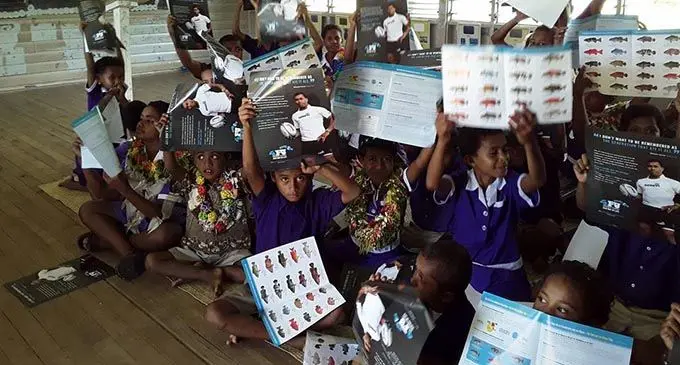 Students holding up charts from the seasonal ban on Kawakawa (Grouper) and Donu (Coral Trouts) awareness programmes carried out by fisheries officers.  Photo: Ministry of Fisheries