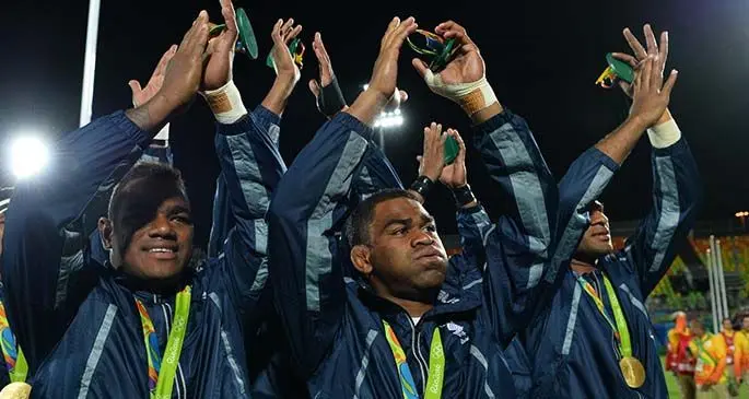 Team Fiji men’s rugby 7s team (left-right0 Josua Tuisova, Vatemo Ravouvou and Jasa Veremalua after winning the gold medal at the 2016 Olympic Games in Rio de Janeiro, Brazil. Photo: World Rugby.