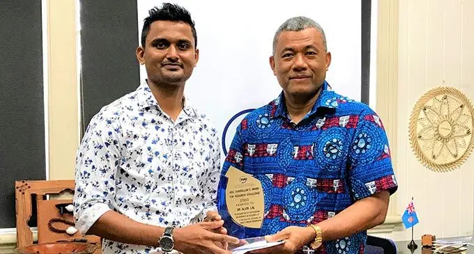 Dr Alvin Lal receives his award from Fiji National University Acting Vic...