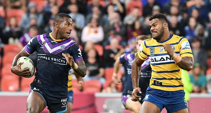 From left: Melbourne Storm winger Suliasi Vunivalu tries to run away from Maika Sivo of the Parramatta Eels in the NRL clash. 