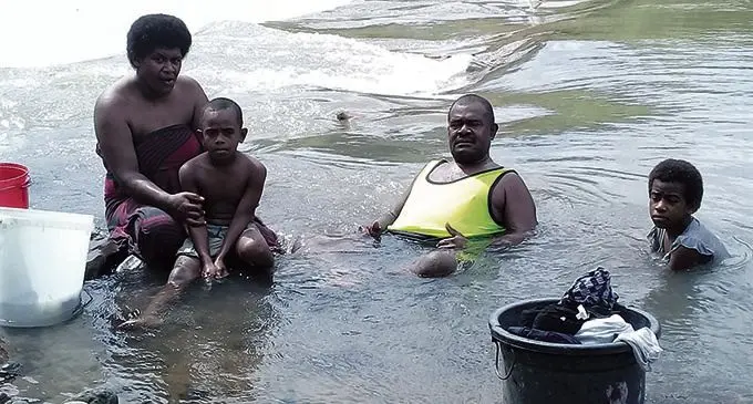 Mere Lico with son Emosi Seru, husband Etuate Nagata and Lusiana Lewavesi who all take a break from doing their Laundry at Paipai River.  Photo: Arvind Pillay